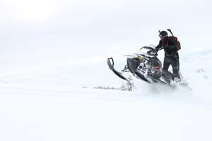 Riding Snowmobile through Powder