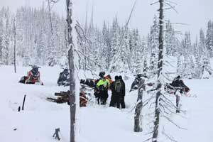 group of snowmobile riders having lunch